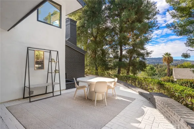 a white bench sitting in front of a house