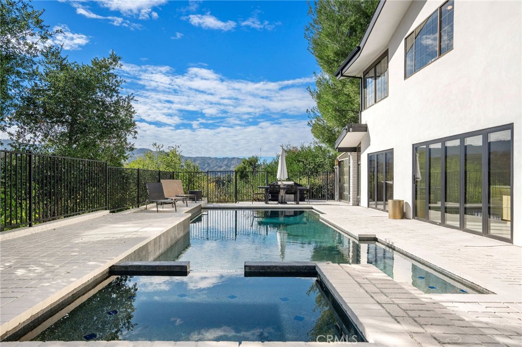 23229 8th Street Newhall, CA 91321 - Photo 10 of 52 a view of a patio with couches and table and chairs and potted plants