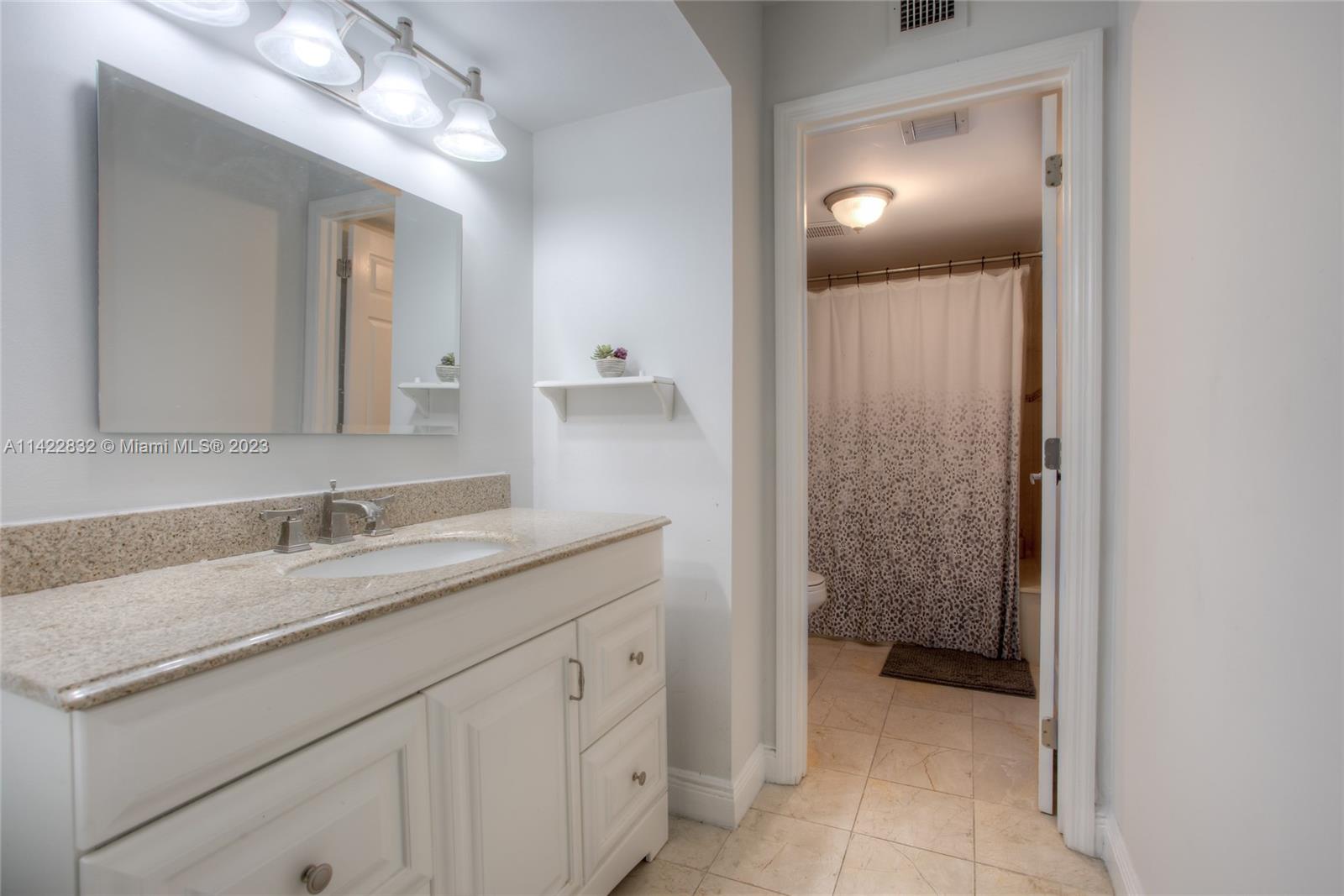 14332 Southwest 97th Lane Miami, FL 33186 - Photo 11 of 15 a bathroom with a sink and a mirror
