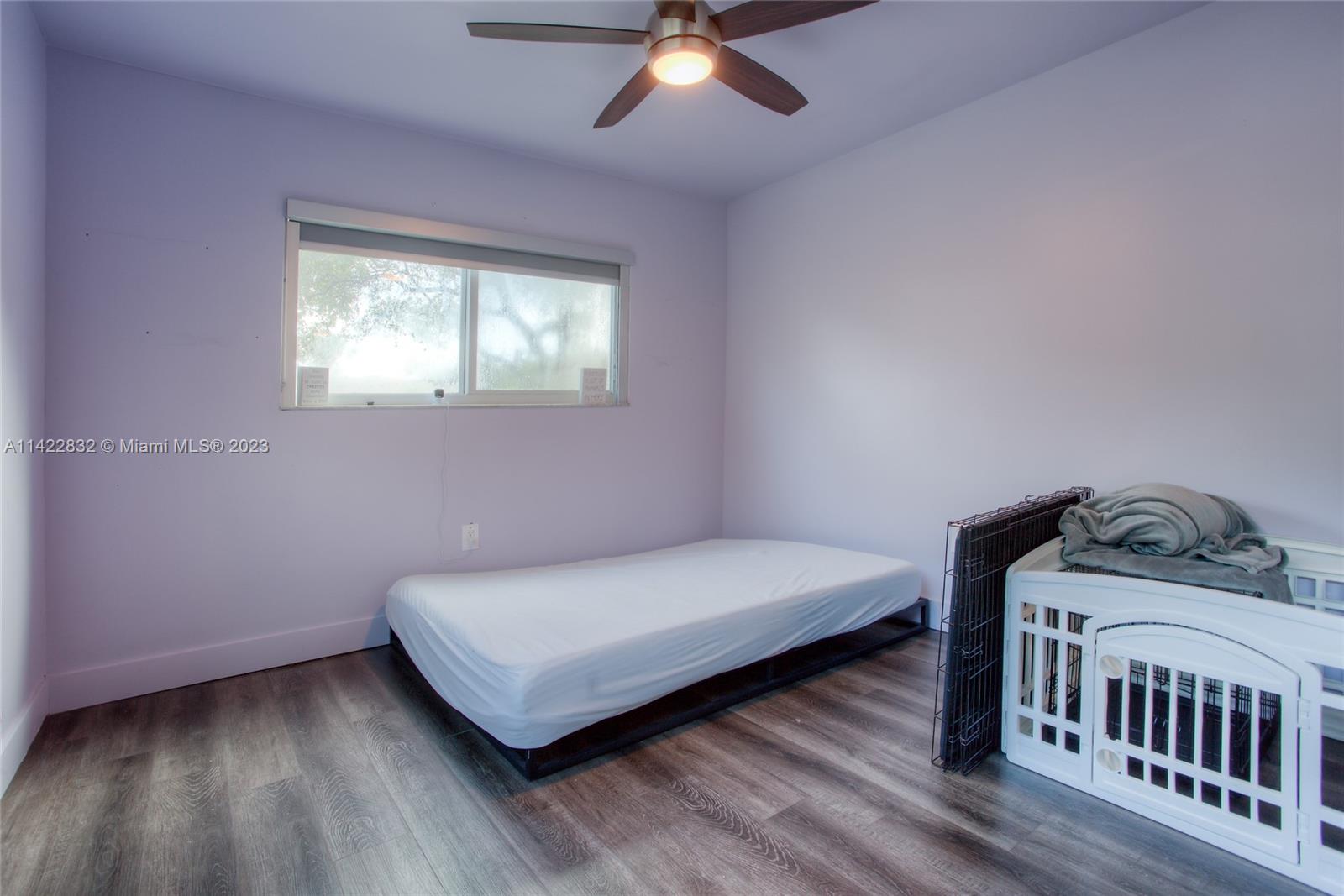 14332 Southwest 97th Lane Miami, FL 33186 - Photo 12 of 15 a bedroom with a bed and window