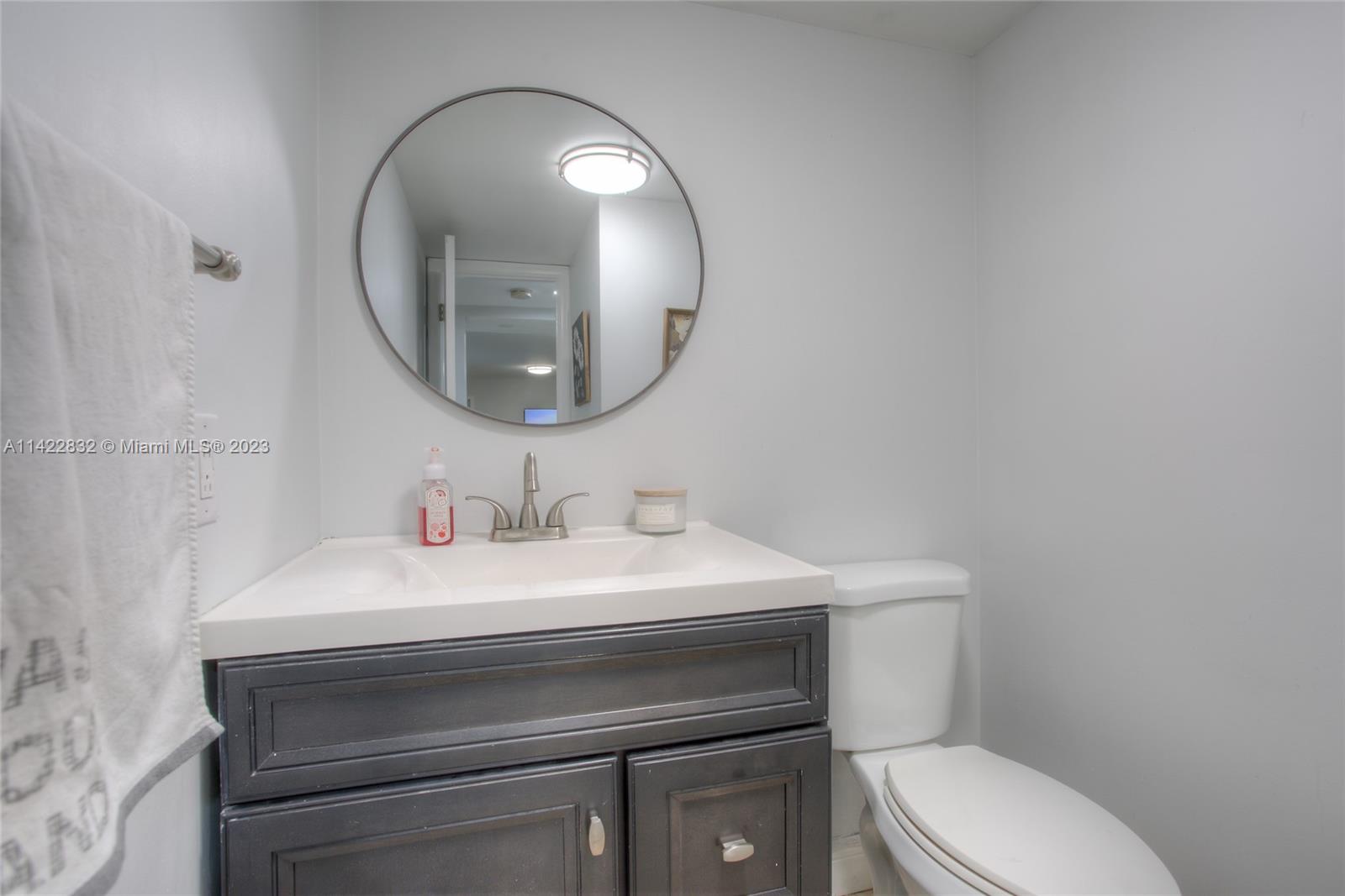 14332 Southwest 97th Lane Miami, FL 33186 - Photo 6 of 15 a bathroom with a toilet a sink and mirror