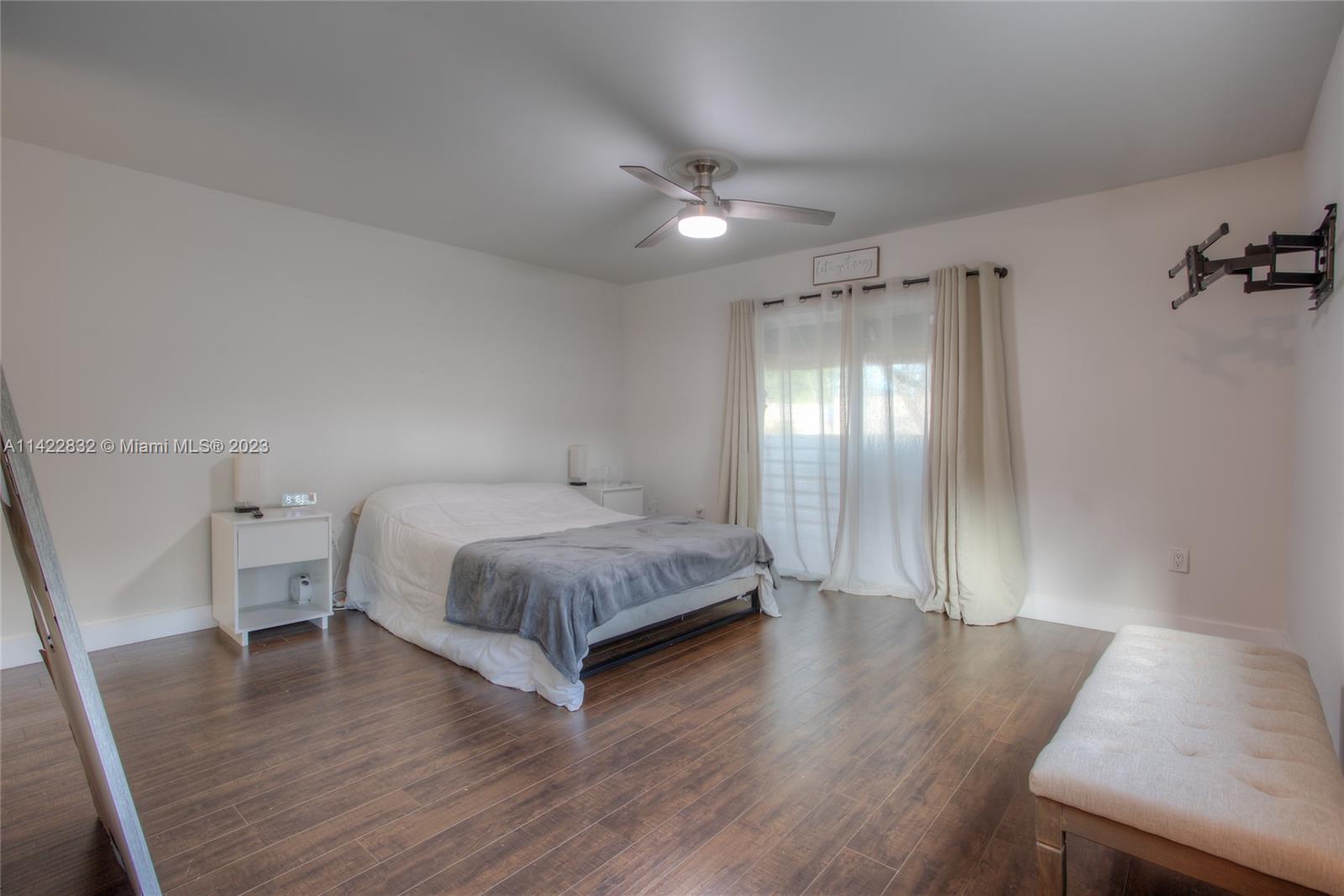 14332 Southwest 97th Lane Miami, FL 33186 - Photo 9 of 15 a bedroom with a bed and a table in it