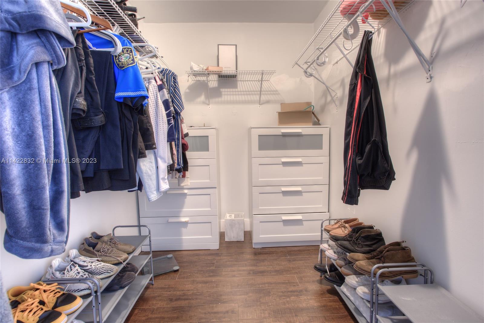 14332 Southwest 97th Lane Miami, FL 33186 - Photo 10 of 15 a view of walk in closet with clothes and shoes