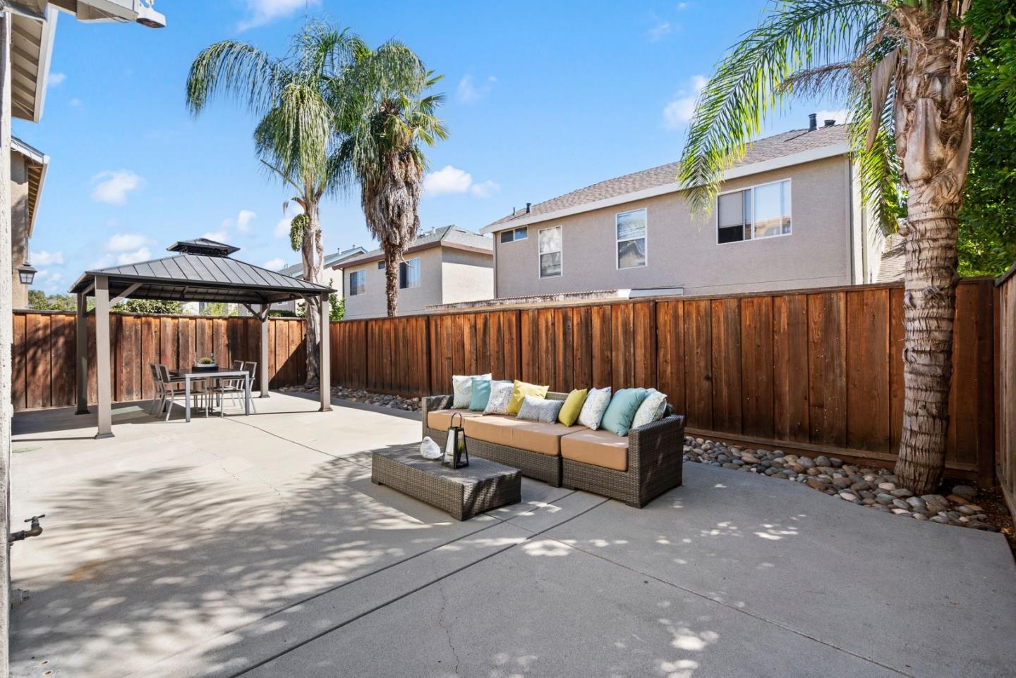 9310 Hirasaki Avenue Gilroy, CA 95020 - Photo 16 of 30 a view of a patio with a table and chairs under an umbrella with a barbeque