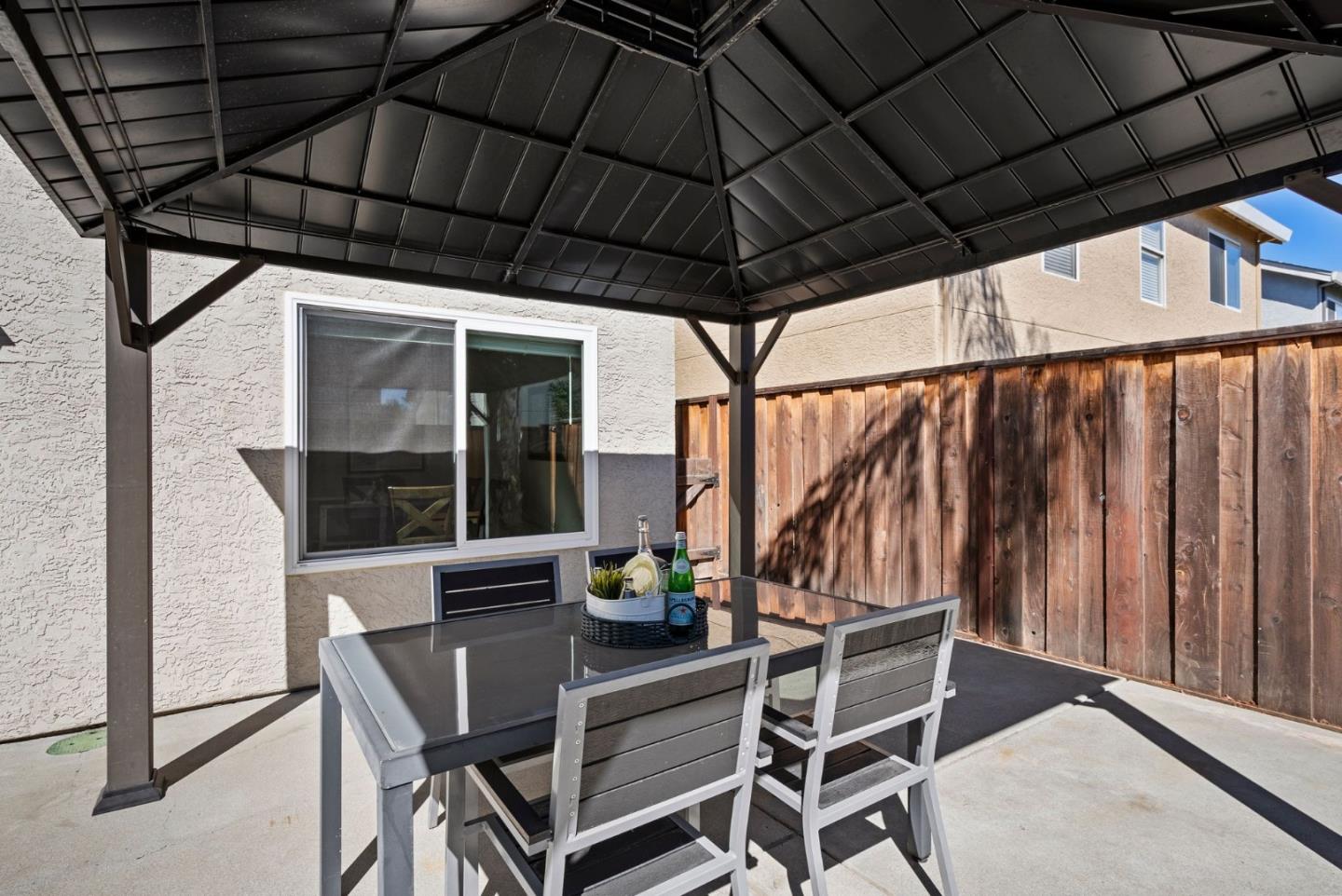9310 Hirasaki Avenue Gilroy, CA 95020 - Photo 20 of 30 a view of patio with table and chairs under an umbrella