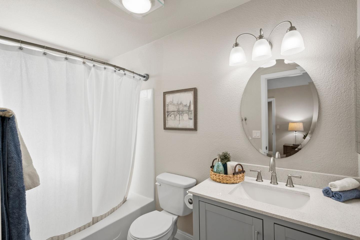 9310 Hirasaki Avenue Gilroy, CA 95020 - Photo 25 of 30 a bathroom with a sink a toilet and a mirror