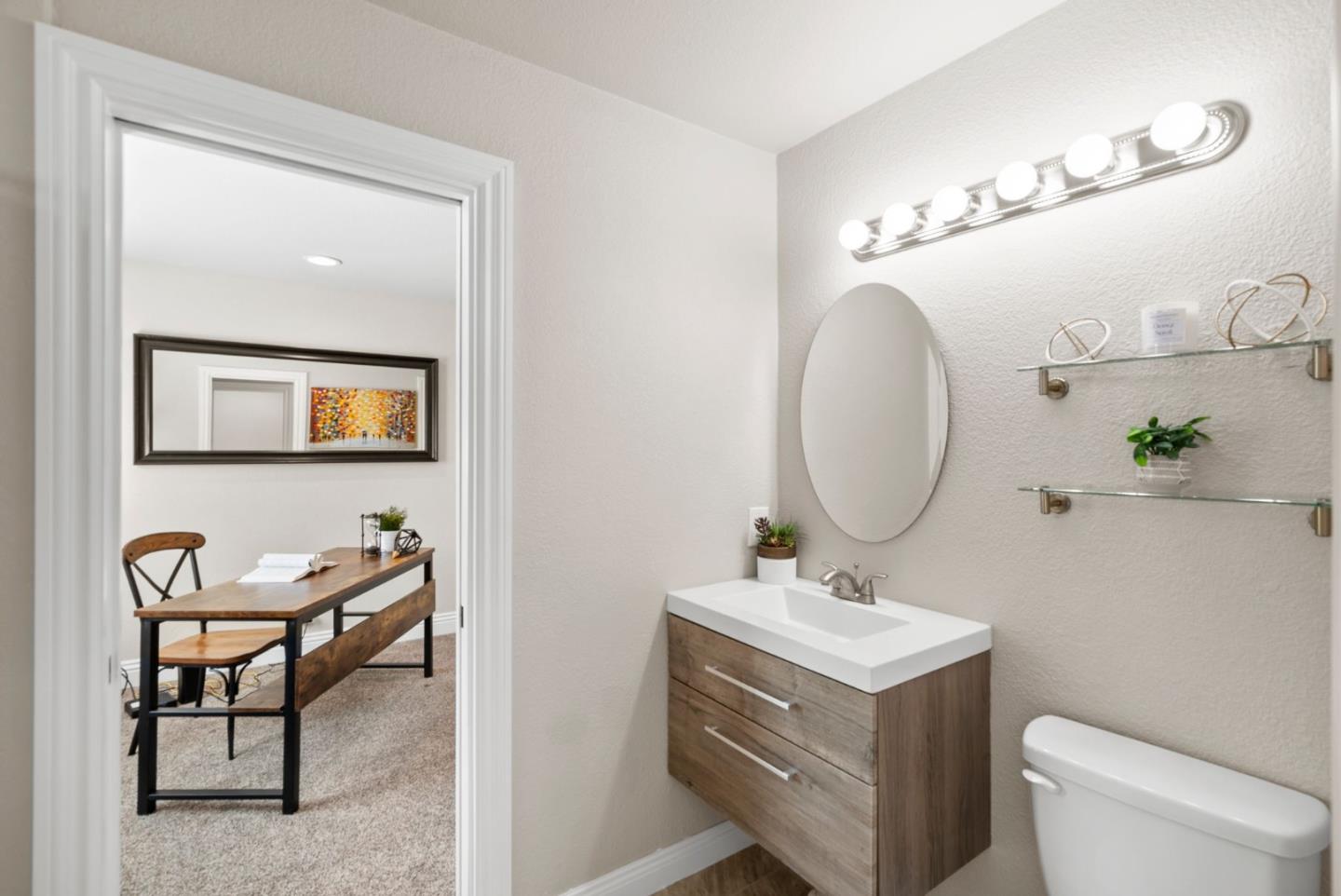 9310 Hirasaki Avenue Gilroy, CA 95020 - Photo 27 of 30 a bathroom with a toilet a sink and a mirror