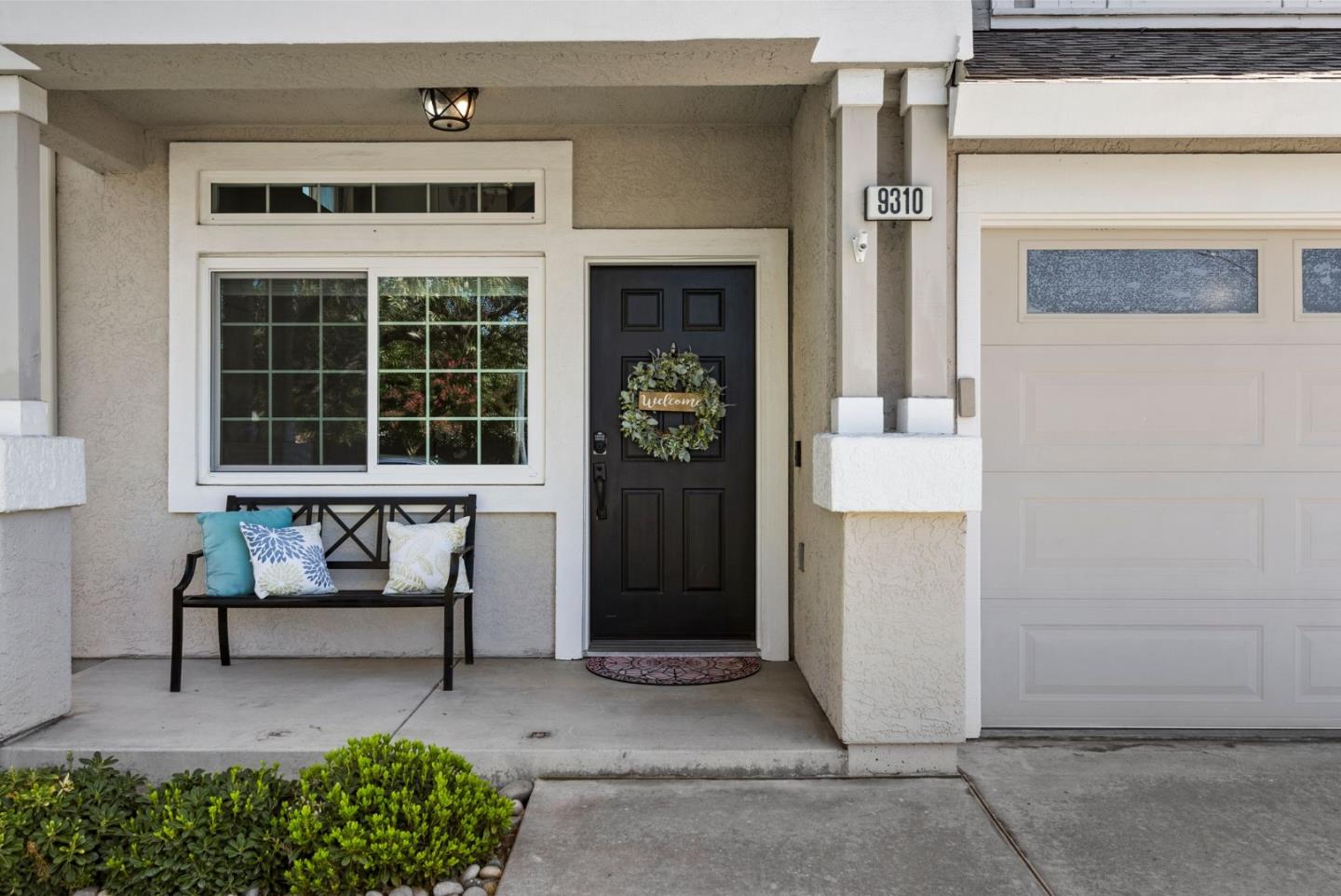 9310 Hirasaki Avenue Gilroy, CA 95020 - Photo 4 of 30 a front view of a house with a bench and a porch