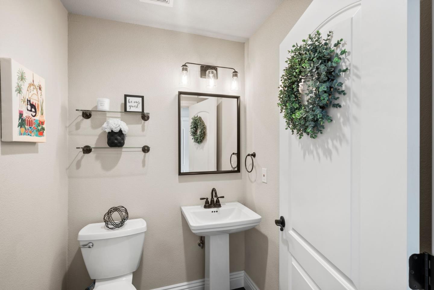 9310 Hirasaki Avenue Gilroy, CA 95020 - Photo 8 of 30 a bathroom with a toilet a sink and mirror