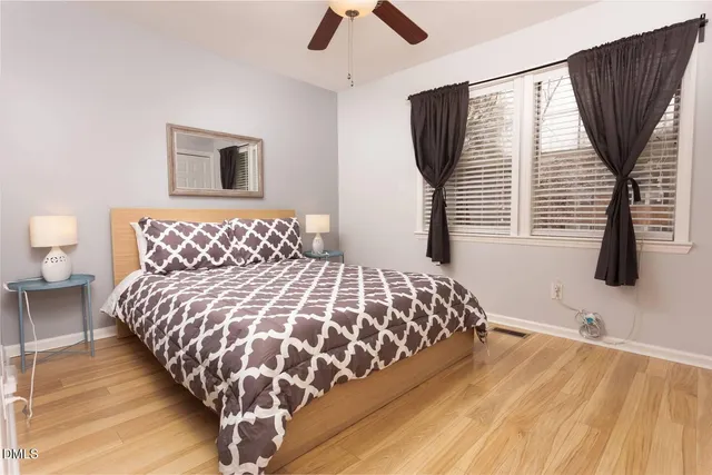 a bedroom with a large bed and a chandelier