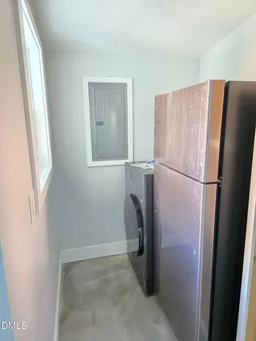 a view of a refrigerator in kitchen and wooden floor