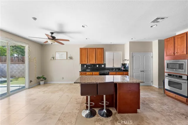a view of kitchen with refrigerator and window