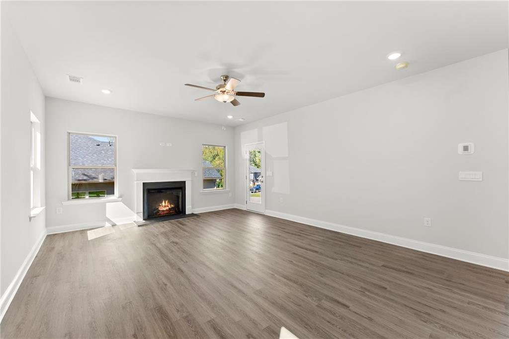 285 Magnolia Villas Drive Cornelia, GA 30531 - Photo 14 of 49 a view of an empty room with a fireplace and a window