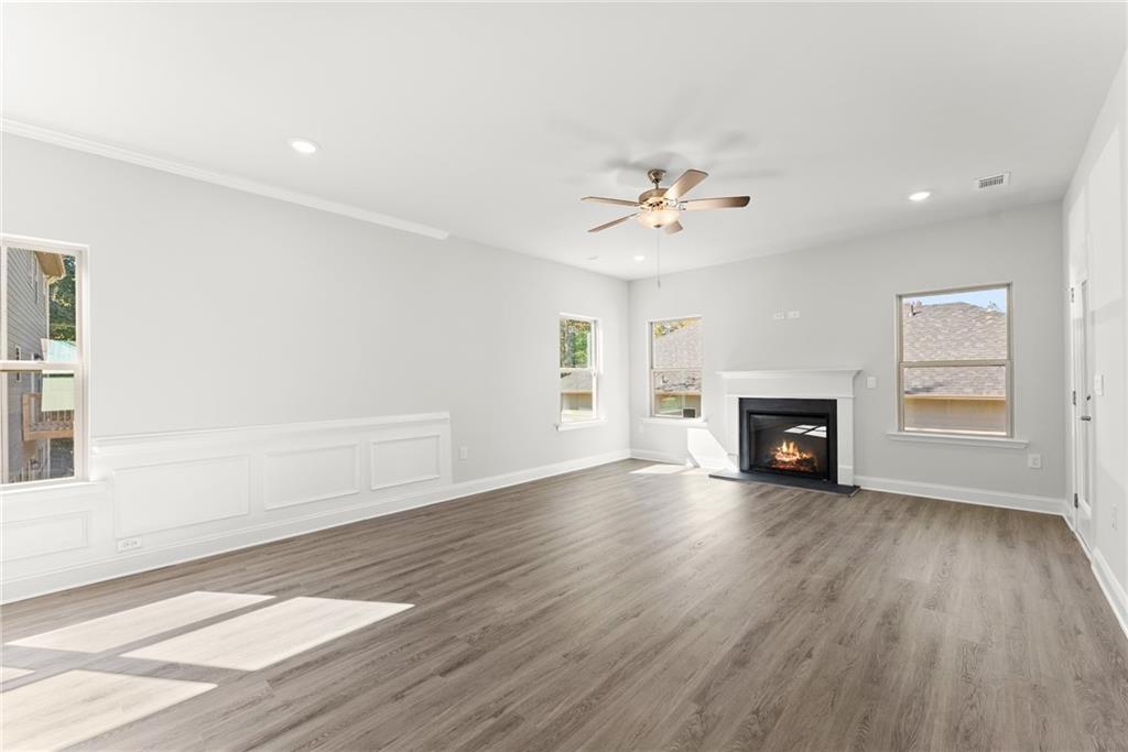 285 Magnolia Villas Drive Cornelia, GA 30531 - Photo 15 of 49 an empty room with wooden floor fireplace and windows