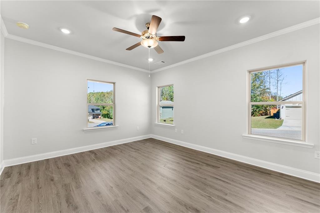 285 Magnolia Villas Drive Cornelia, GA 30531 - Photo 17 of 49 a view of an empty room with wooden floor and a window