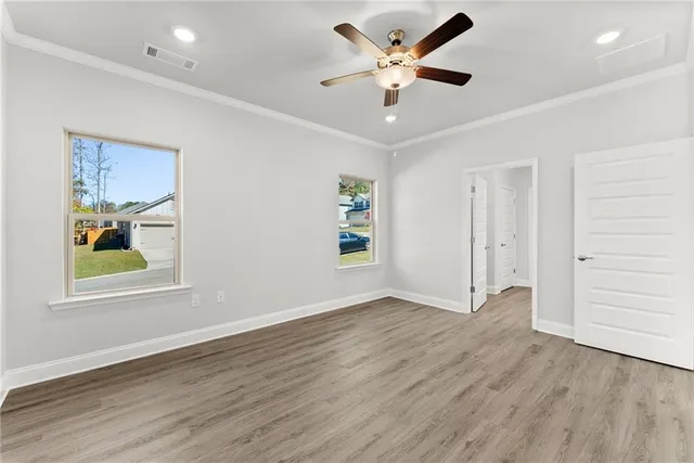 wooden floor in an empty room with a window