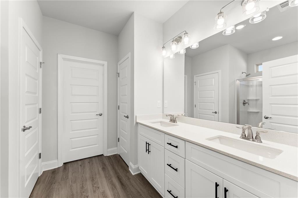 285 Magnolia Villas Drive Cornelia, GA 30531 - Photo 22 of 49 a spacious bathroom with a granite countertop sink a mirror and a shower