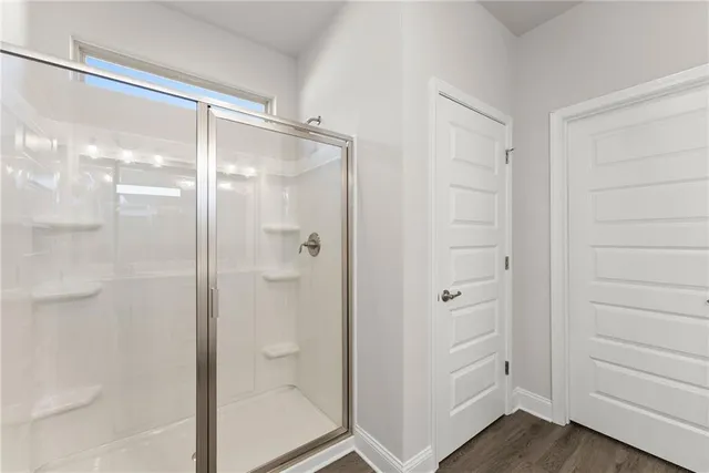 a bathroom with a glass shower door