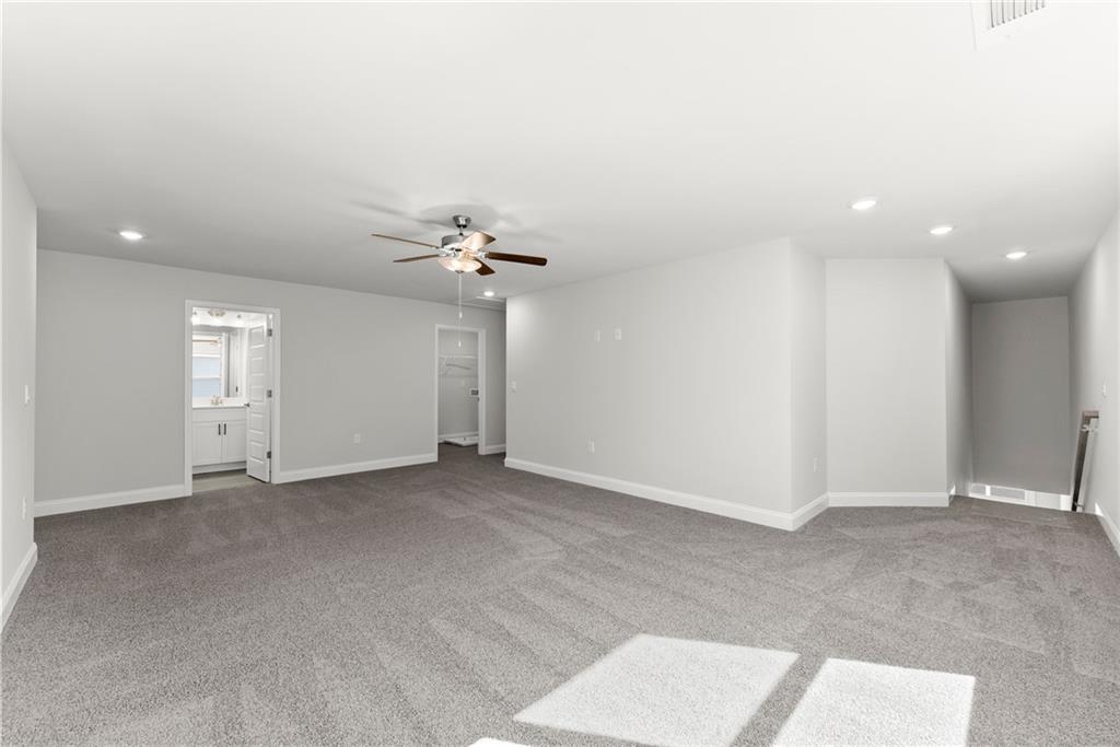 285 Magnolia Villas Drive Cornelia, GA 30531 - Photo 25 of 49 an empty room with windows and chandelier fan