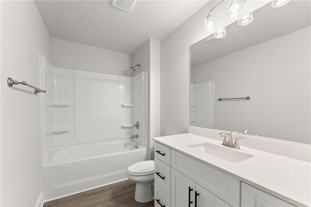 285 Magnolia Villas Drive Cornelia, GA 30531 - Photo 33 of 49 a bathroom with a toilet a sink a mirror a bathtub and vanity