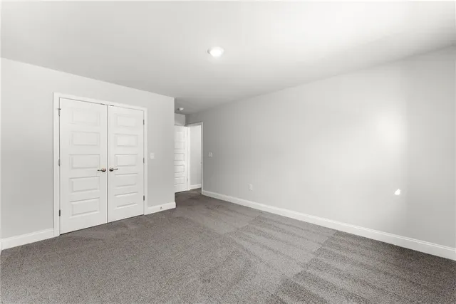 an empty room with closet area