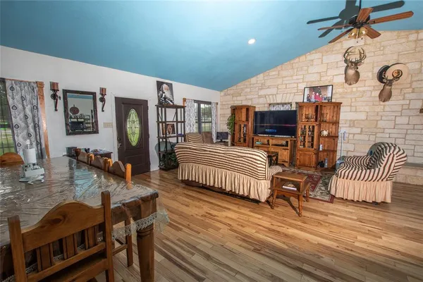a bedroom with a bed and flat tv screen on the dresser
