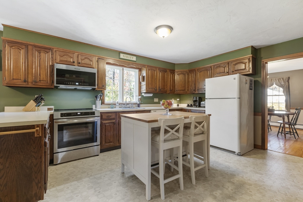 103 Uxbridge Street Douglas, MA 01569 - Photo 11 of 38 a kitchen with a stove a sink and a refrigerator
