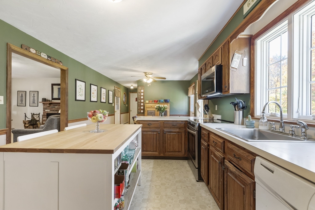 103 Uxbridge Street Douglas, MA 01569 - Photo 13 of 38 a kitchen with a sink stove and cabinets