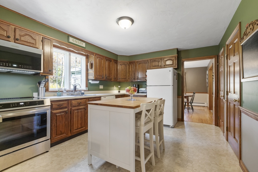 103 Uxbridge Street Douglas, MA 01569 - Photo 15 of 38 a kitchen with a stove a refrigerator and a sink