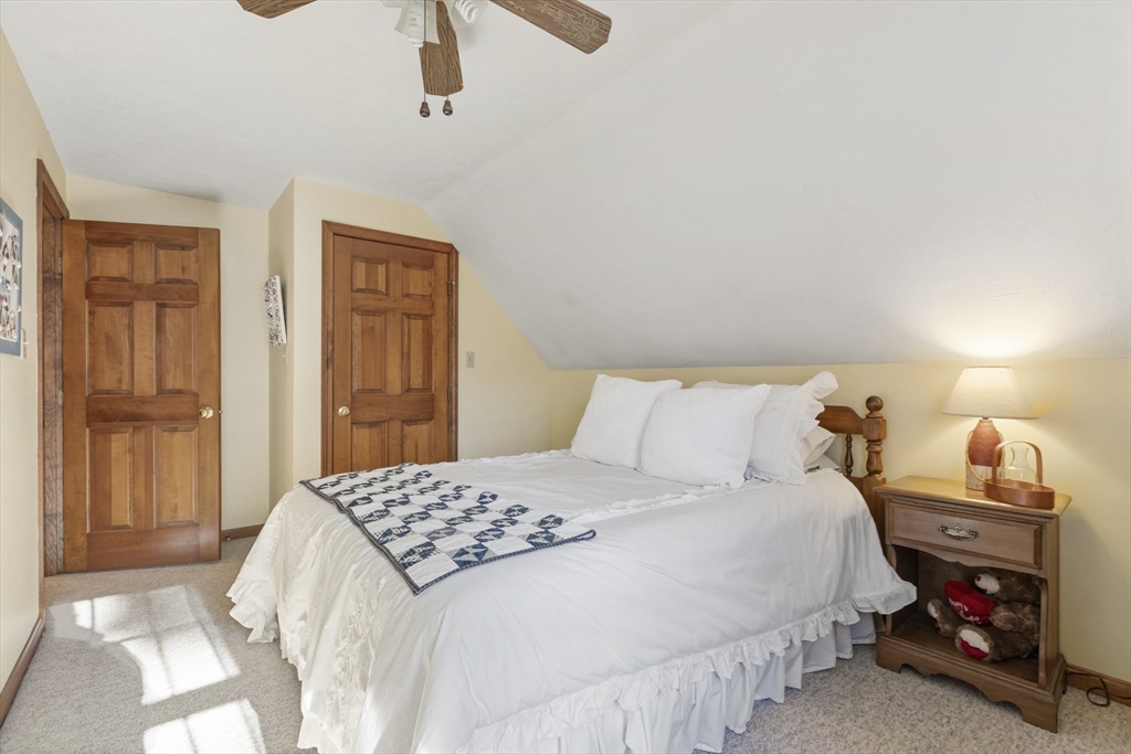 103 Uxbridge Street Douglas, MA 01569 - Photo 30 of 38 a bedroom with a bed and a lamp