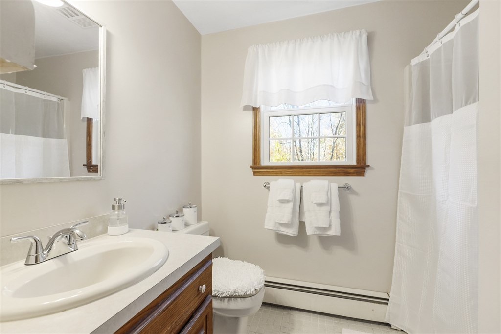 103 Uxbridge Street Douglas, MA 01569 - Photo 36 of 38 a bathroom with a sink toilet and mirror