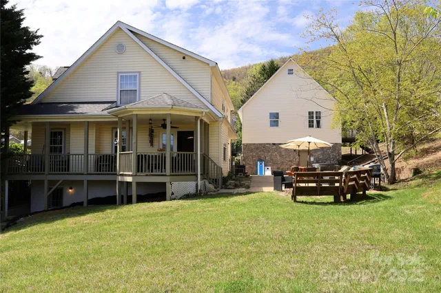 a view of a house with a yard porch and sitting area