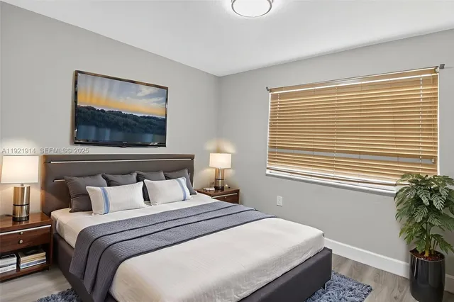 a bedroom with a bed and a potted plant