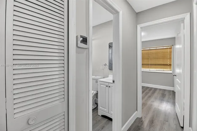 a view of a bathroom from a hallway