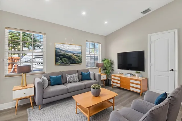 a living room with furniture and a flat screen tv