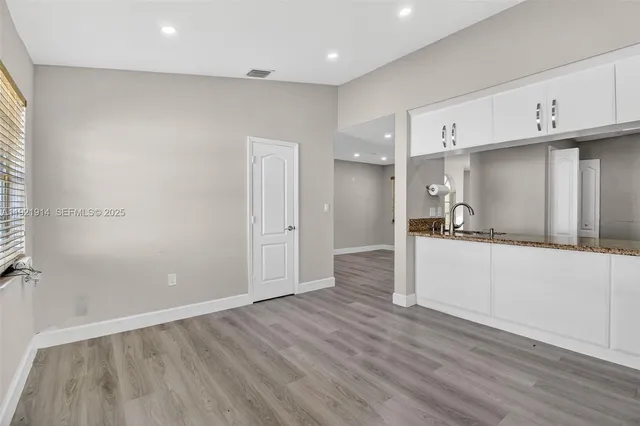 a view of cabinets and wooden floor