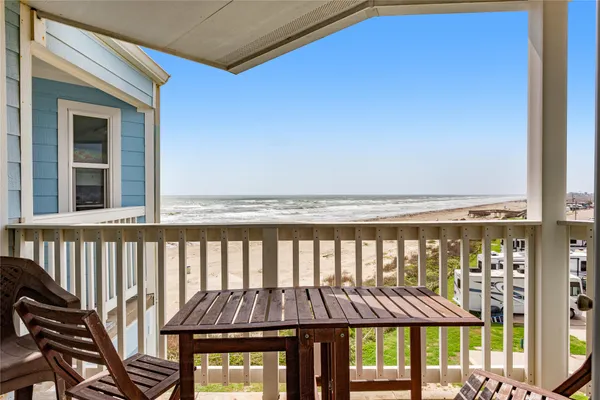 a view of a balcony with an outdoor seating