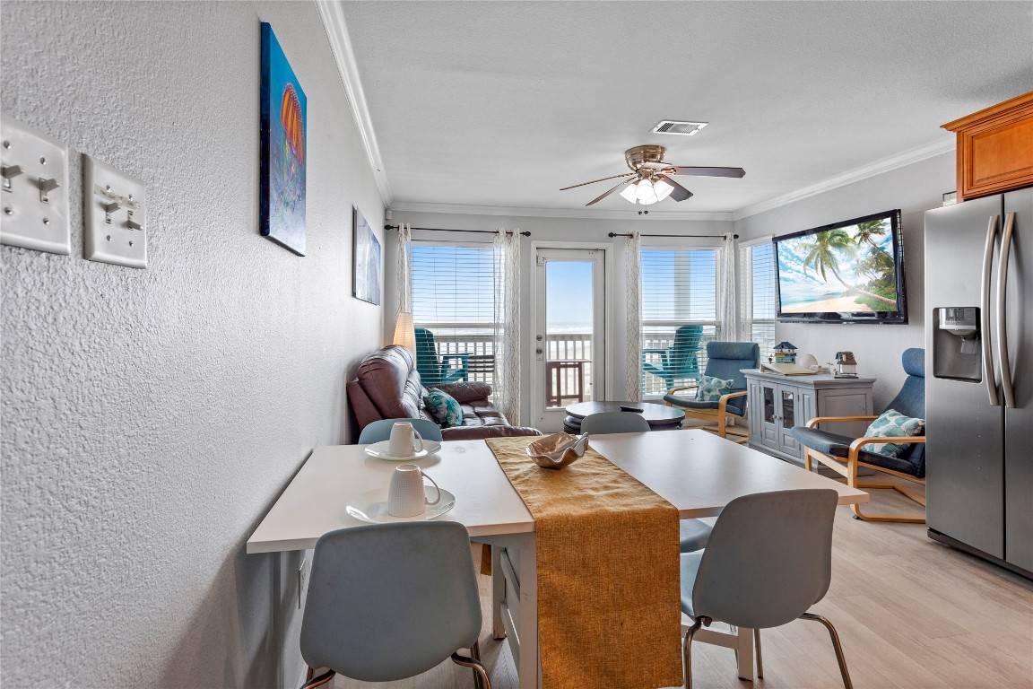 10811 Termini-San Luis Pass Road, Unit 1307 Galveston, TX 77554 - Photo 11 of 28 a view of a dining room with furniture window and wooden floor
