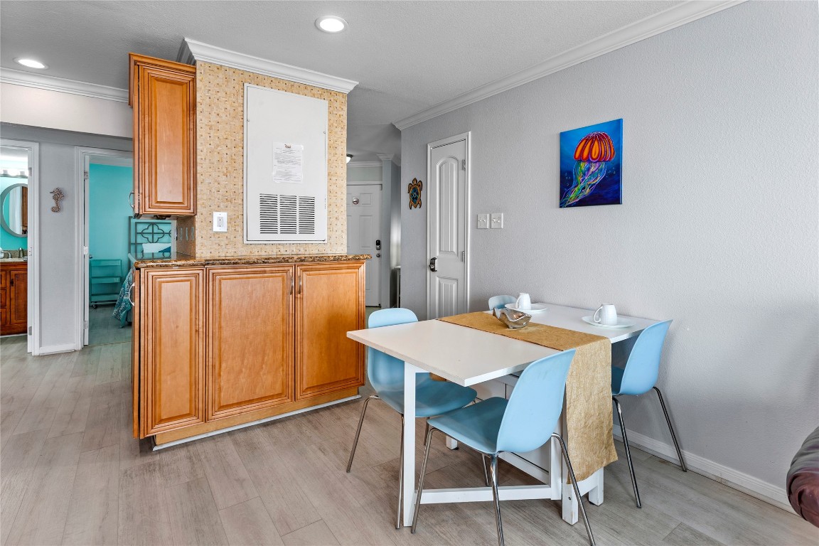 10811 Termini-San Luis Pass Road, Unit 1307 Galveston, TX 77554 - Photo 12 of 28 a view of a dining room with furniture window and wooden floor
