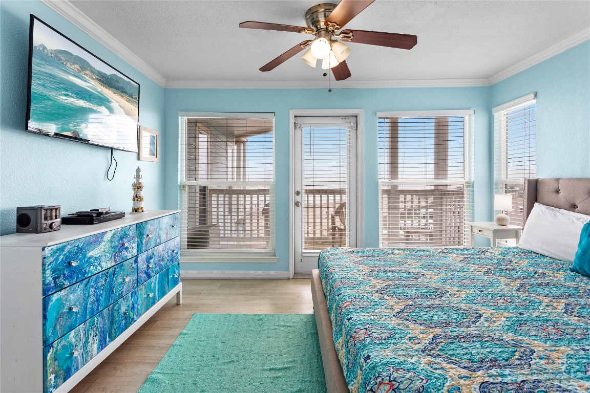 10811 Termini-San Luis Pass Road, Unit 1307 Galveston, TX 77554 - Photo 13 of 28 a bed room with a bed and a large window