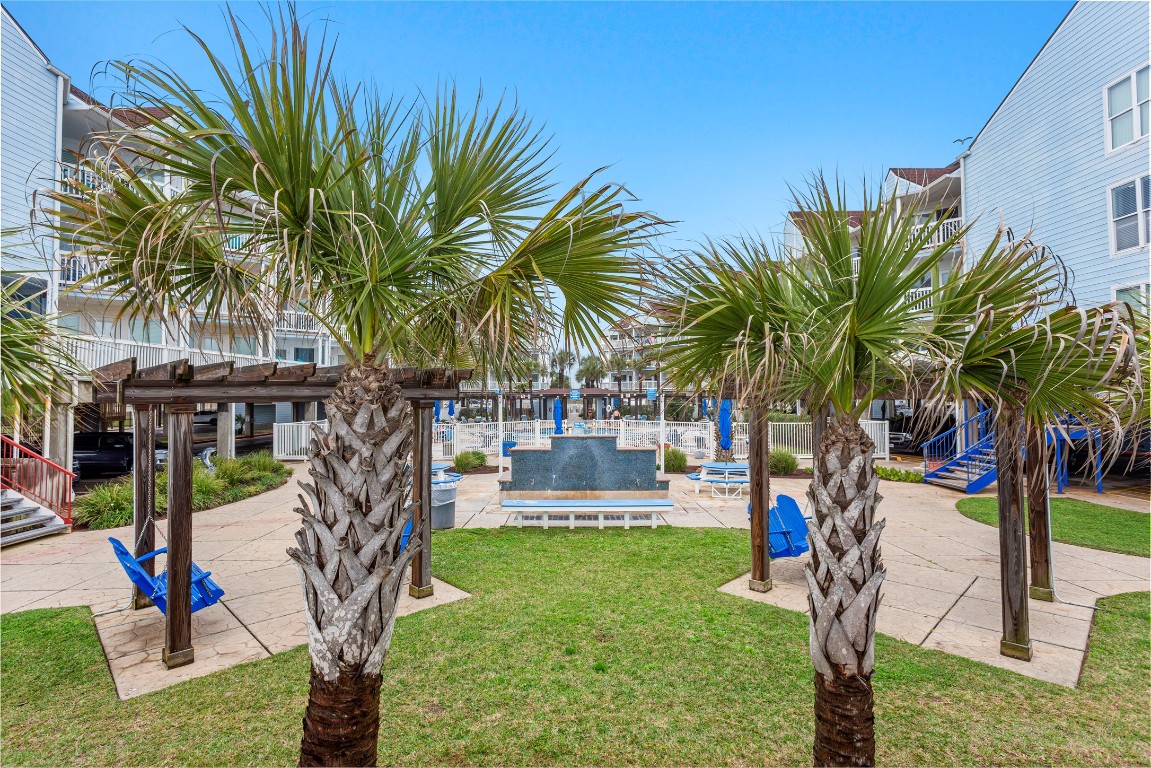 10811 Termini-San Luis Pass Road, Unit 1307 Galveston, TX 77554 - Photo 22 of 28 a park with lots of palm trees and slides