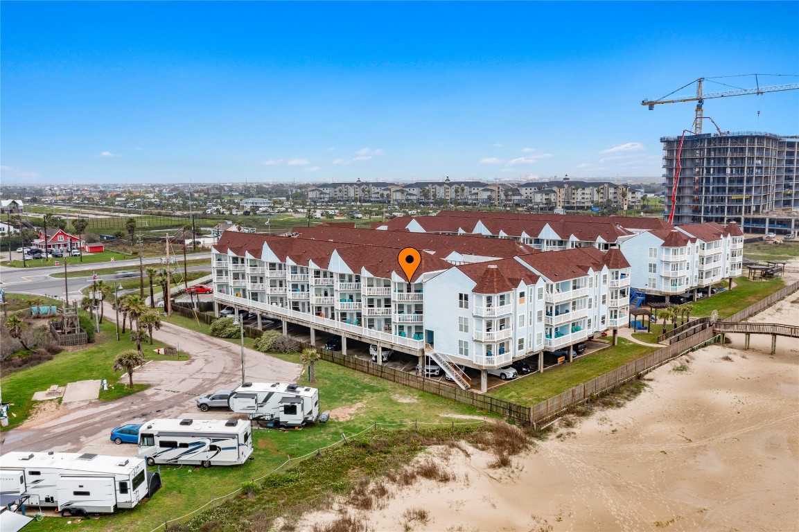 10811 Termini-San Luis Pass Road, Unit 1307 Galveston, TX 77554 - Photo 27 of 28 a view of a city with lawn chairs