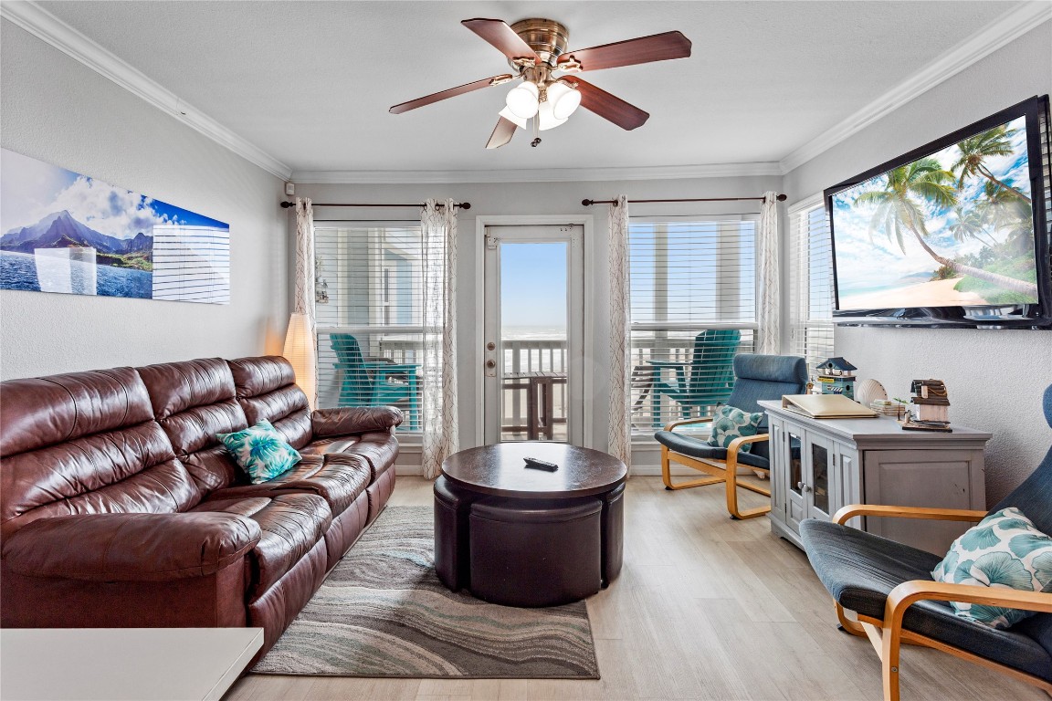 10811 Termini-San Luis Pass Road, Unit 1307 Galveston, TX 77554 - Photo 4 of 28 a living room with furniture a large window and a flat screen tv