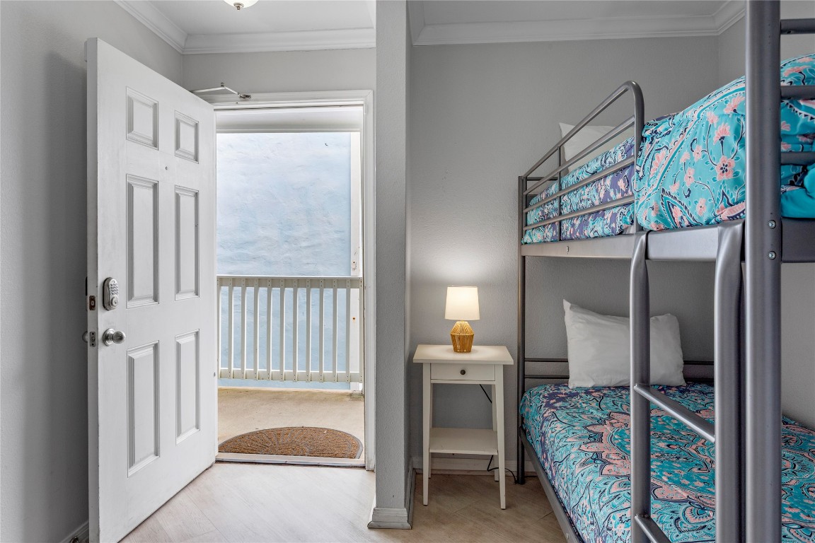 10811 Termini-San Luis Pass Road, Unit 1307 Galveston, TX 77554 - Photo 6 of 28 a bedroom with furniture and a window