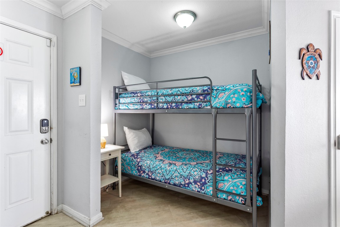 10811 Termini-San Luis Pass Road, Unit 1307 Galveston, TX 77554 - Photo 7 of 28 a bedroom with a bed and a table