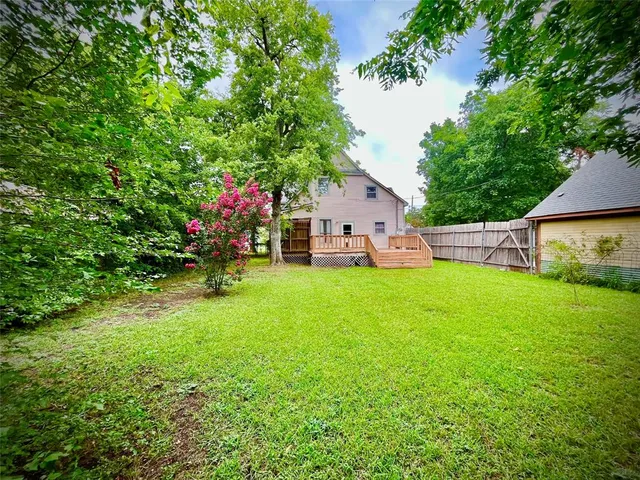 a view of house with backyard space and garden
