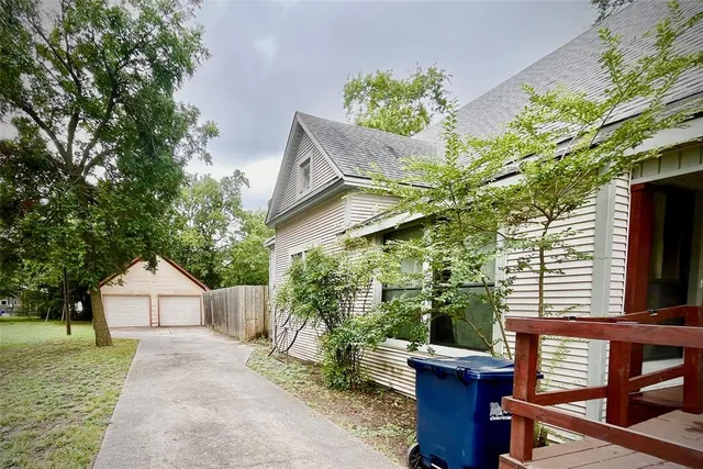 a view of backyard of house with green space