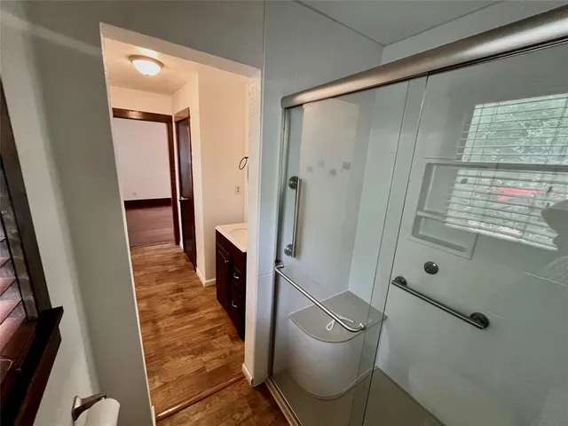 a bathroom with a sink and mirror with toilet