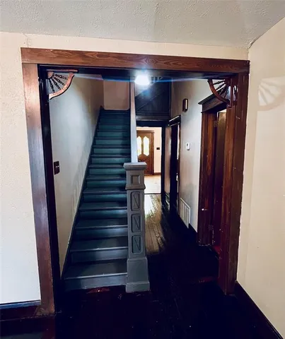 a view of entryway and hall with wooden floor