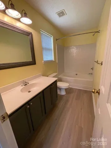 an empty room with fan and entrance